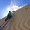 75602-process-power-washing-vinyl-siding-employee-on-top-ladder